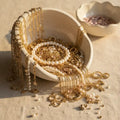MystiBox mystery jewelry scoop with gold necklaces, pearl bracelets, and surprise fashion jewelry